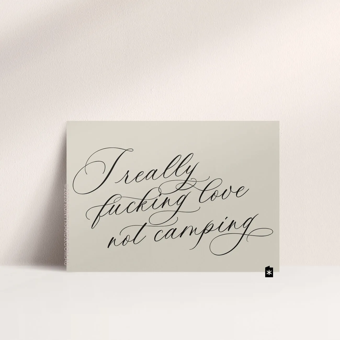 Best easter card - Grey card with black ink printed in script font on the front that says "I really fucking love not camping" made in Perth WA by Kunty Kards
